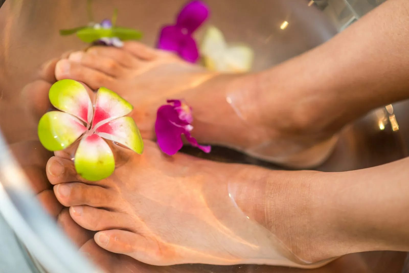Spa pedicure foot bath with fresh flowers