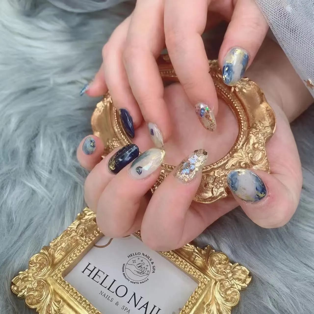 Navy marble manicure with gold foil accents